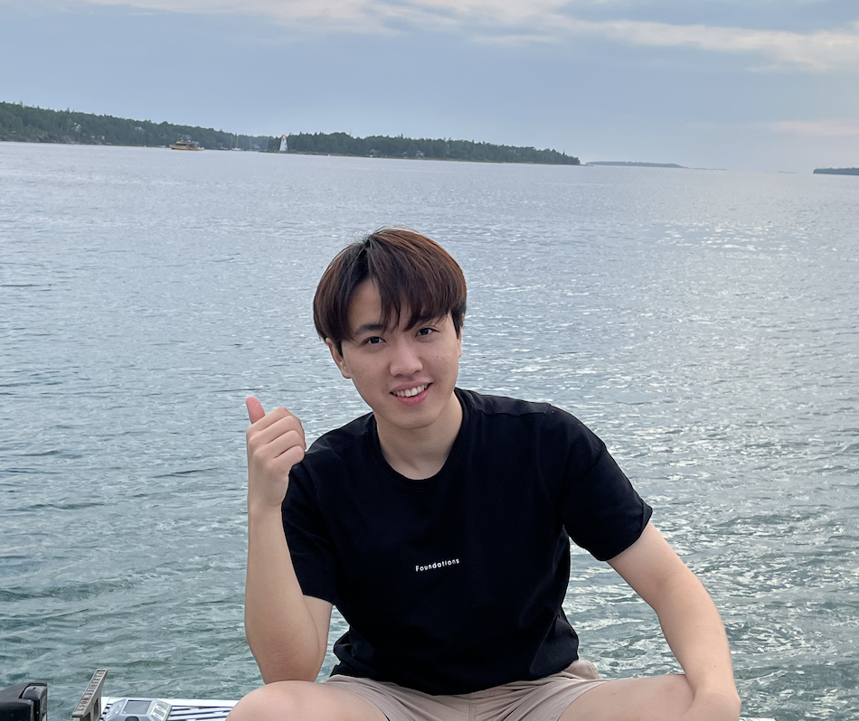 Jianbin Cui smiling by the water